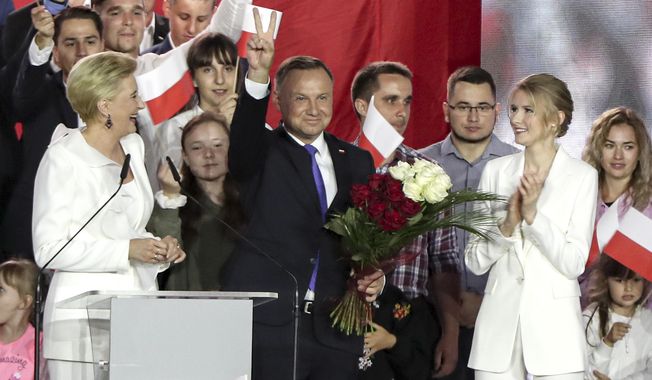 Incumbent President Andrzej Duda flashes a victory sign in Pultusk, Poland, Sunday, July 12, 2020. An exit poll in Poland&#x27;s presidential runoff election shows a tight race that is too close to call between the conservative incumbent, Andrzej Duda, and the liberal Warsaw mayor, Rafal Trzaskowski.(AP Photo/Czarek Sokolowski)