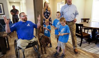Purple Heart veteran U.S. Army Sgt. 1st Class Travis Vendela, left, his wife, Tiffany, center, their three sons, Kaiden, Quentin and Trayden, and Andrew McClure, Tunnel to Towers national community engagement coordinator, tour the Vendelas&#39; new home in Huntsville, Weber County, on Friday, July 3, 2020. (Laura Seitz/The Deseret News via AP)