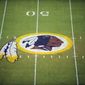  In this Aug. 28, 2009 file photo, the Washington Redskins logo is shown on the field before the start of a preseason NFL football game against the New England Patriots in Landover, Md.  The Washington NFL franchise announced Monday that it will drop the Redskins name and Indian head logo immediately, bowing to decades of criticism that they are offensive to Native Americans.  (AP Photo/Nick Wass, File)  **FILE**