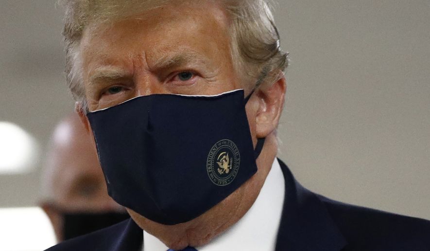 President Donald Trump wears a face mask as he visits Walter Reed National Military Medical Center in Bethesda, Md., Saturday, July 11, 2020. (AP Photo/Patrick Semansky)