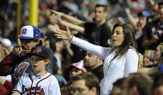 In this May 2, 2014, photo, Atlanta Braves fans do the tomahawk chop during the ninth inning of a baseball game with the San Francisco Giants, in Atlanta. The Atlanta Braves say they have no plans to follow the lead of the NFL&#39;s Washington Redskins and change their team name. The team said in a letter to season ticket holders they are examining the fan experience, including the tomahawk chop chant, and have formed a &amp;quot;cultural working relationship&amp;quot; with the Eastern Band of the Cherokees in North Carolina. (AP Photo/David Tulis) **FILE**