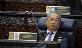 Prime Minister Muhyiddin Yassin attending parliament session at parliament lower house in Kuala Lumpur, Malaysia, Monday, July 13, 2020. (AP Photo/Vincent Thian)