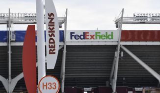Signs for the Washington Redskins are displayed outside FedEx Field in Landover, Md., Monday, July 13, 2020. The Washington NFL franchise announced Monday that it will drop the &amp;quot;Redskins&amp;quot; name and Indian head logo immediately, bowing to decades of criticism that they are offensive to Native Americans. (AP Photo/Susan Walsh)