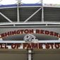 Signs for the Washington Redskins are displayed outside FedEx Field in Landover, Md., Monday, July 13, 2020.  The Washington NFL franchise announced Monday that it will drop the “Redskins” name and Indian head logo immediately, bowing to decades of criticism that they are offensive to Native Americans. (AP Photo/Susan Walsh)