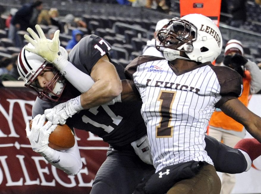 In this Nov. 22, 2014, file photo, Lafayette wide receiver Matt Mrazek, left, catches a touchdown pass as Lehigh cornerback Oliver Riguad defends during the second half of an NCAA college football Patriot League game at Yankee Stadium in New York. The Patriot League joined the Ivy League on Monday, July 13, 2020, punting on a fall football season because of the coronavirus pandemic while holding out hope that it could be made up in the second academic semester. (AP Photo/Bill Kostroun) ** FILE **