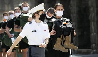A West Point cadet leads a formation of new cadets, Monday, July 13, 2020, at the U.S. Military Academy in West Point, N.Y. The Army is welcoming more than 1,200 candidates from every state. Candidates will be COVID-19 tested immediately upon arrival, wear masks, and practice social distancing. (AP Photo/Mark Lennihan)