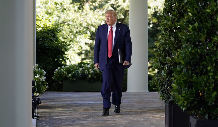 President Donald Trump walks from the Oval Office to speak in the Rose Garden of the White House, Tuesday, July 14, 2020, in Washington. (AP Photo/Evan Vucci)