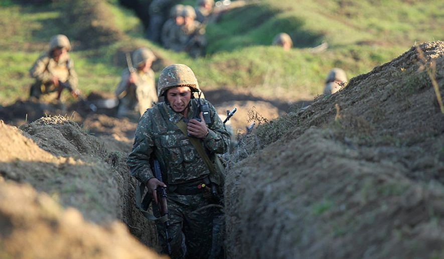 Armenian soldiers take their position on the front line in Tavush region, Armenia, Tuesday, July 14, 2020. Skirmishes on the volatile Armenia-Azerbaijan border escalated Tuesday, marking the most serious outbreak of hostilities between the neighbors since the fighting in 2016. (Armenian Defense Ministry Press Service/PanPhoto via AP)