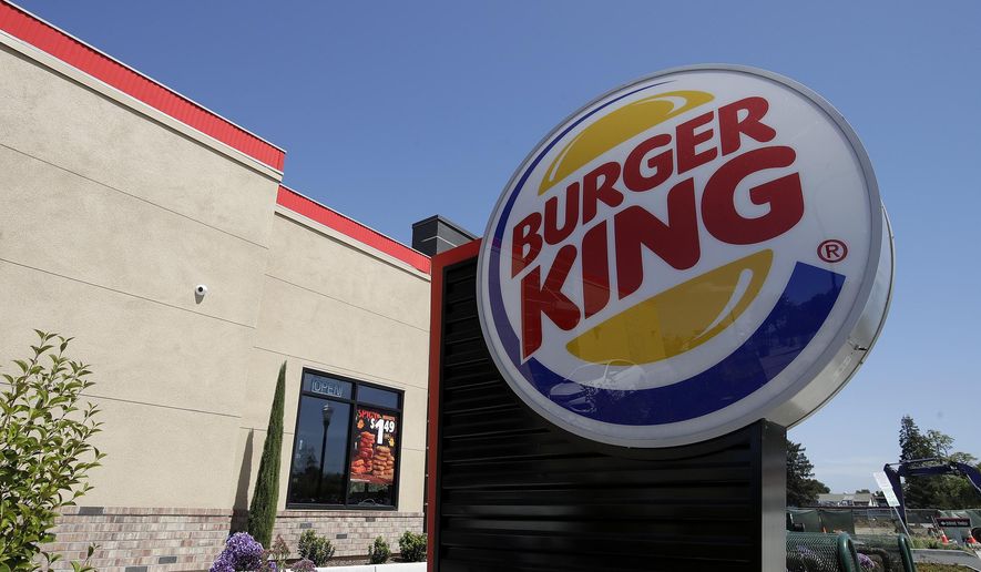 This April 25, 2019, file photo shows a Burger King in Redwood City, Calif. Burger King is announcing its work to help address a core industry challenge: the environmental impact of beef.  To help tackle this environmental issue, the Burger King brand partnered with top scientists to develop and test a new diet for cows, which according to initial study results, on average reduces up to 33% of cows&#39; daily methane emissions. (AP Photo/Jeff Chiu, File)  **FILE**