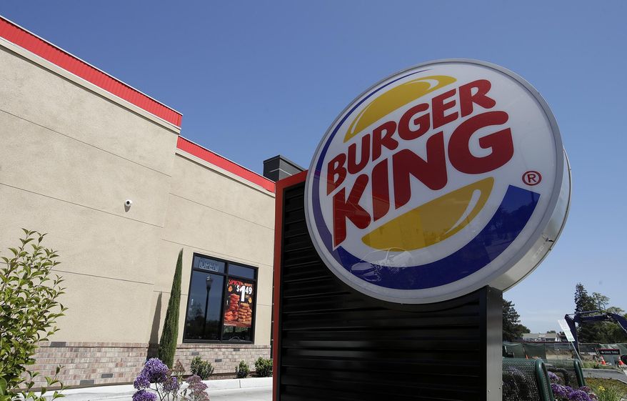 This April 25, 2019, file photo shows a Burger King in Redwood City, Calif. Burger King is announcing its work to help address a core industry challenge: the environmental impact of beef.  To help tackle this environmental issue, the Burger King brand partnered with top scientists to develop and test a new diet for cows, which according to initial study results, on average reduces up to 33% of cows&#39; daily methane emissions. (AP Photo/Jeff Chiu, File)  **FILE**