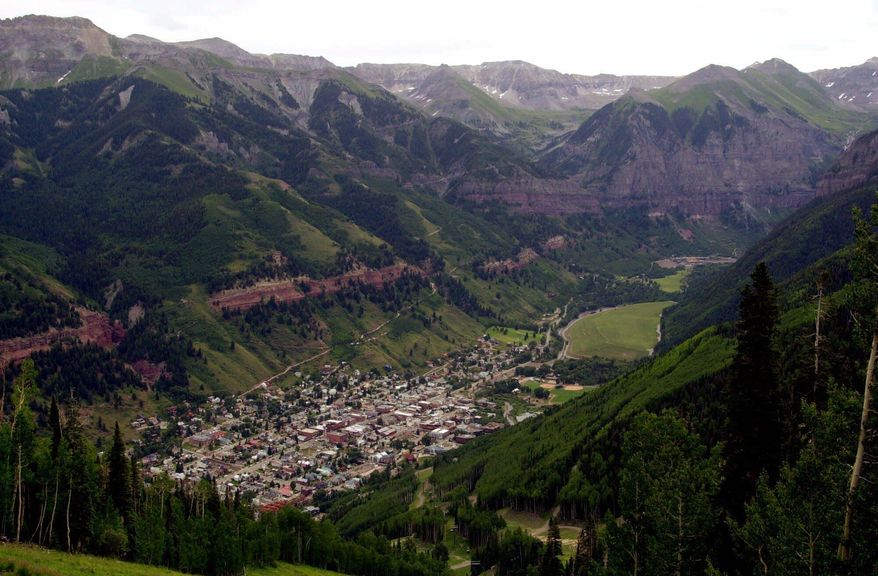 FILE - In this July 17, 2001, file photo, a view of Telluride, Colo. appears nestled in a valley from the top of Mount St. Sophia. The Telluride Film Festival, the annual film retreat held in the Colorado mountains and one of the fall movie season's top launching pads, has been canceled. Festival organizers said Tuesday that its 47th edition, scheduled for Labor Day weekend, has been scuttled entirely due to the coronavirus pandemic. (AP Photo/Ed Andrieski/File)