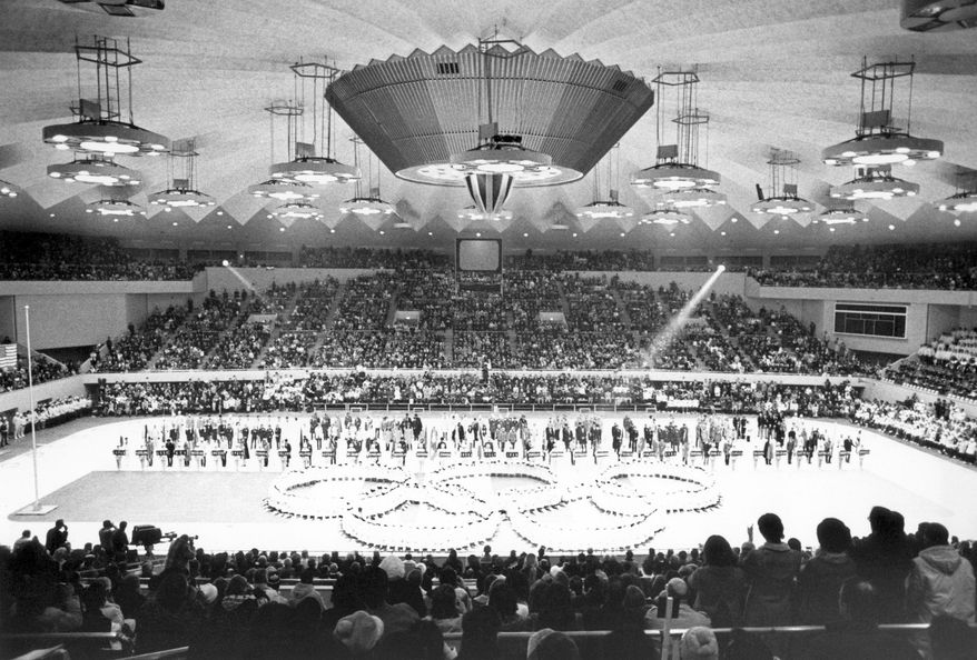 FILE - In this Feb. 13, 1972, file photo, Olympic rings in the center of the Makomanai ice arena is seen during the closing ceremony of the Winter Olympics, in Sapporo, Japan. Yasuhiro Yamashita, the president of the Japanese Olympic Committee, said Tuesday, July 14, 2020, that if Tokyo can pull off next year’s Summer Olympics, then the Japanese city of Sapporo could be in good standing with a bid to hold the 2030 Winter Olympics.  (AP Photo)