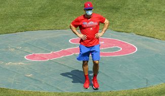 FILE - In this July 3, 2020, file photo, Philadelphia Phillies manager Joe Girardi looks on from the pitchers mound during a baseball training session in Philadelphia. (AP Photo/Chris Szagola, File)
