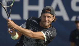 FILE - In this Aug. 26, 2019, file photo, Lucas Pouille, of France, returns a shot to Philipp Kohlschreiber, of Germany, during the first round of the U.S. Open tennis tournament in New York. Former top-10 tennis pro Lucas Pouille will have surgery on his right elbow and miss the return of sanctioned tennis — if the tours do return in August from their pandemic-forced hiatus. The 26-year-old Frenchman said Tuesday, July 14, 2020, on Twitter that he would have the operation in Paris this month. (AP Photo/Steve Luciano, File)