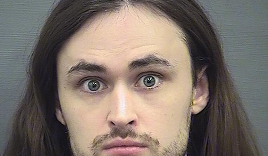 This photo provided by the Alexandria Sheriff's Office shows John C. Denton, founder and former leader of a neo-Nazi group who has pleaded guilty to conspiring to place hoax phone calls targeting an African American church, a Cabinet official, journalists and others. Denton, 26, of Montgomery, Texas, faces up to five years in prison after entering a guilty plea Tuesday, July 14, 2020 in federal court in Alexandria to conspiring to transmit threats. (Alexandria Sheriff's Office via AP)