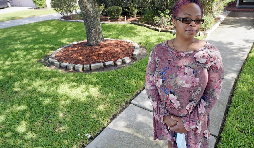 Parent and teacher Stacey Pugh poses for a photograph outside her home Monday, July 13, 2020, in Humble, Texas. While children have proven to be less susceptible to the coronavirus, teachers are vulnerable. “I will be wearing a mask, a face shield, possibly gloves, and I’m even considering getting some type of body covering to wear,” says Pugh, a fifth-grade teacher in suburban Houston. (AP Photo/David J. Phillip)