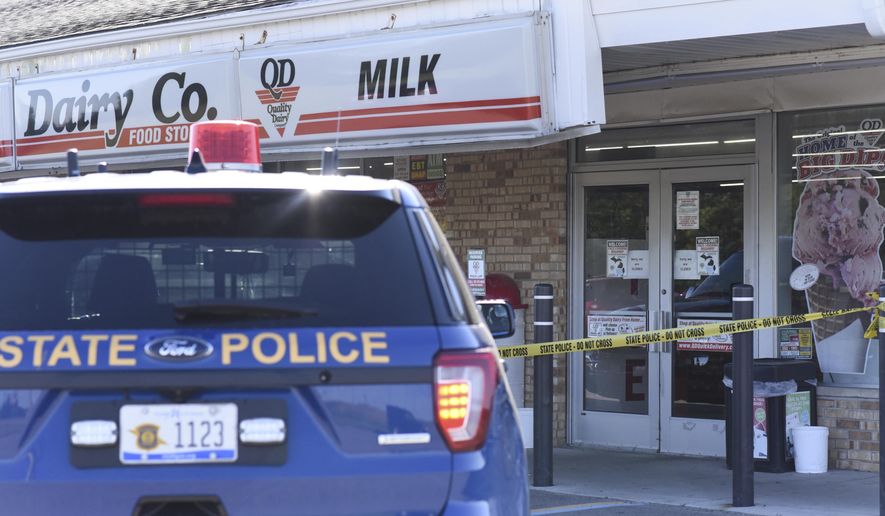 The scene where a 77-year-old man was stabbed by a 43-year-old man Tuesday morning, July 14, 2020, outside of a Quality Dairy on Lansing Road in Windsor Township, Michigan. A Grand Ledge man who stabbed an elderly man outside a Quality Dairy store after being refused service for not wearing a mask was shot and killed by an Eaton County deputy several miles away, Michigan State Police said. (Matthew Dae Smith/Lansing State Journal via AP)
