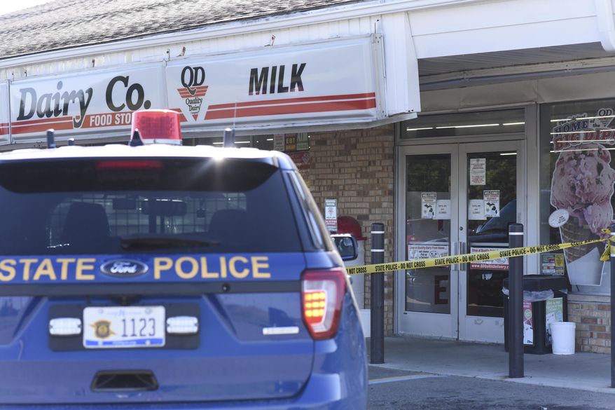 The scene where a 77-year-old man was stabbed by a 43-year-old man Tuesday morning, July 14, 2020, outside of a Quality Dairy on Lansing Road in Windsor Township, Michigan. A Grand Ledge man who stabbed an elderly man outside a Quality Dairy store after being refused service for not wearing a mask was shot and killed by an Eaton County deputy several miles away, Michigan State Police said. (Matthew Dae Smith/Lansing State Journal via AP)