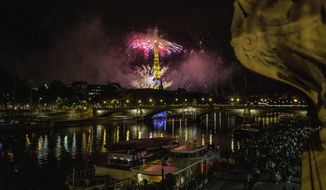 Fireworks illuminate the Eiffel Tower in Paris during Bastille Day celebrations late Tuesday, July 14, 2020. Bastille Day marks the July 14, 1789, storming of the Bastille prison by angry Paris crowds that helped spark the French Revolution. (AP Photo/Rafael Yaghobzadeh)