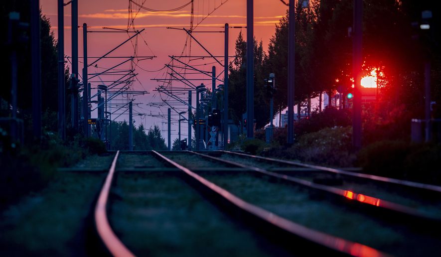 Rails of a subway line are seen in Frankfurt, Germany, as the sun rises Saturday, June 27, 2020. (AP Photo/Michael Probst)