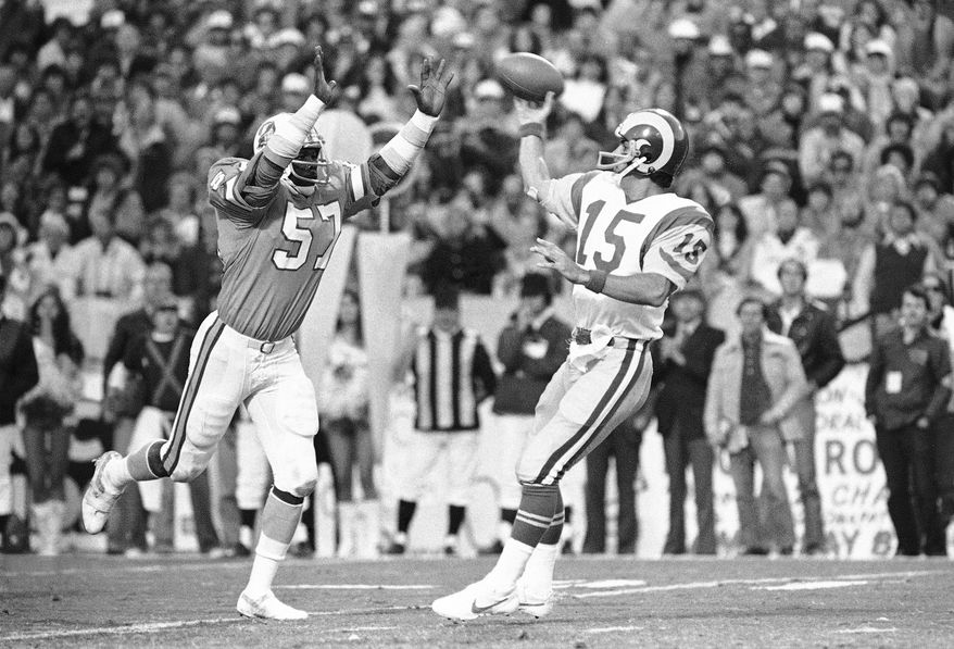 FILE - In this Sunday, Jan. 6, 1980, file photo, Tampa Bay Buccaneers' David Lewis, left, pressures Los Angeles Rams quarterback Vince Ferragamo during the NFC championship NFL football game in Tampa. Lewis, a key member of the Buccaneers’ historic 1979 team that reached the NFC title game, has died. He was 65.  Lewis died Tuesday, July 14, 2020, in Tampa. The cause was not immediately known, but he had struggled with health issues in recent years. (AP Photo/File)