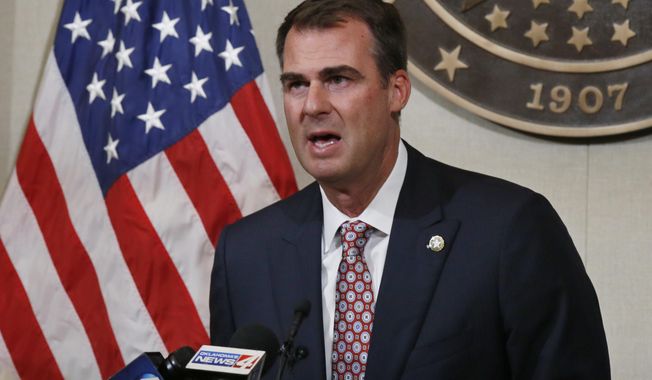 FILE - In this July 9, 2020, file photo Oklahoma Gov. Kevin Stitt speaks during a news conference in Oklahoma City. Stitt announced Wednesday, July 15, 2020, that he's tested positive for the coronavirus and that he is isolating at home. The first-term Republican governor has backed one of the country's most aggressive reopening plans, has resisted any statewide mandate on masks and rarely wears one himself. (AP Photo/Sue Ogrocki, File)