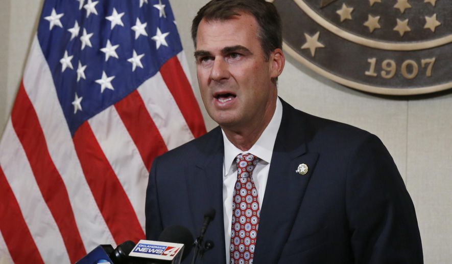 FILE - In this July 9, 2020, file photo Oklahoma Gov. Kevin Stitt speaks during a news conference in Oklahoma City. Stitt announced Wednesday, July 15, 2020, that he's tested positive for the coronavirus and that he is isolating at home. The first-term Republican governor has backed one of the country's most aggressive reopening plans, has resisted any statewide mandate on masks and rarely wears one himself. (AP Photo/Sue Ogrocki, File)