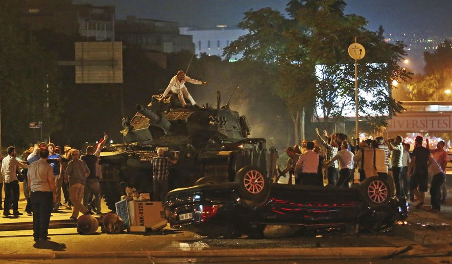 FILE - In this Saturday, July 16, 2016 file photo, tanks move into position as Turkish people attempt to stop them, in Ankara, Turkey. Turkey is marking the fourth anniversary of the July 15 failed coup attempt against the government on Wednesday July 15, 2020, with ceremonies and events remembering its victims. (AP Photo/File)