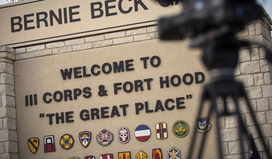 In this April 2, 2014, file photo, members of the media wait outside of the Bernie Beck Gate, an entrance to the Fort Hood military base in Fort Hood, Texas. (AP Photo/Tamir Kalifa, File)  **FILE**