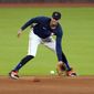 Houston Astros shortstop Carlos Correa fields a ground ball during a baseball practice Wednesday, July 15, 2020, in Houston. (AP Photo/David J. Phillip)