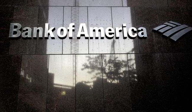 FILE - In this Monday, Oct. 14, 2019 file photo a Bank of America logo is attached to the exterior of the Bank of America Financial Center building, in Boston. Consumer banking giant Bank of America saw its profits drop by more than half in the second quarter, the bank reported Thursday, July 16, 2020, as the bank set aside billions of dollars to cover potentially bad loans caused by the pandemic.  (AP Photo/Steven Senne, File)