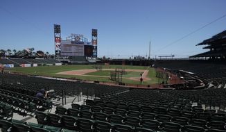 San Francisco Giants players work out at baseball practice at Oracle Park in San Francisco, Tuesday, July 14, 2020. (AP Photo/Jeff Chiu)