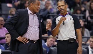 FILE - In this Jan. 4, 2020, fie photo, New Orleans Pelicans head coach Alvin Gentry, left, talks with referee Eric Lewis during the second half of an NBA basketball game in Sacramento, Calif. NBA players have been back on the court for a few weeks, some of that time being individual workouts before practices could resume when the 22 teams arrived at the Walt Disney World bubble. NBA referees haven’t had that chance. There’s a healthy amount of nervous anxiety for those who operate the whistles at NBA games right now, with exhibition games set to begin next week. (AP Photo/Rich Pedroncelli, File)