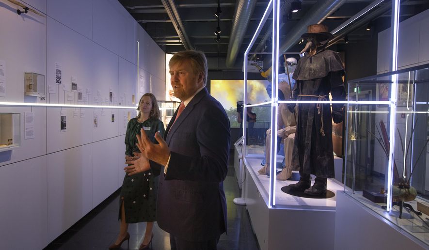 Dutch King Willem-Alexander and curator Mieneke te Hennepe, left, tour the &amp;quot;Contagious!&amp;quot; exhibit at Rijksmuseum Boerhave in Leiden, Netherlands, Thursday, July 16, 2020. The museum finally opened an exhibition Thursday on contagious diseases through the ages after a long delay caused by the disease currently sweeping the world, COVID-19. (AP Photo/Peter Dejong, Pool)