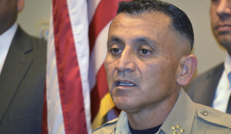 FILE - In this Nov. 28, 2017, file photo, Bernalillo County Sheriff Manuel Gonzales speaks at a news conference in Albuquerque, N.M., after another one of his deputies was involved in a shooting. Gonzales said Wednesday, July 15, 2020, he is looking to partner with a company so deputies can put smartphones in their vests and record video instead of using body cameras. (AP Photo/Russell Contreras, File)