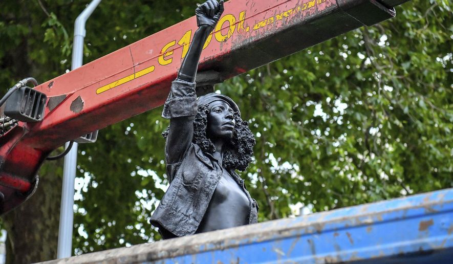 Contractors remove the statue &amp;quot;A Surge of Power (Jen Reid) 2020&amp;quot; by artist Marc Quinn, which had been installed on the site of the fallen statue of the slave trader Edward Colston, in Bristol, England, Thursday, July 16, 2020. The sculpture of protester Jen Reid was installed without the knowledge or consent of Bristol City Council and was removed by the council 24 hours later. (Ben Birchall/PA via AP)
