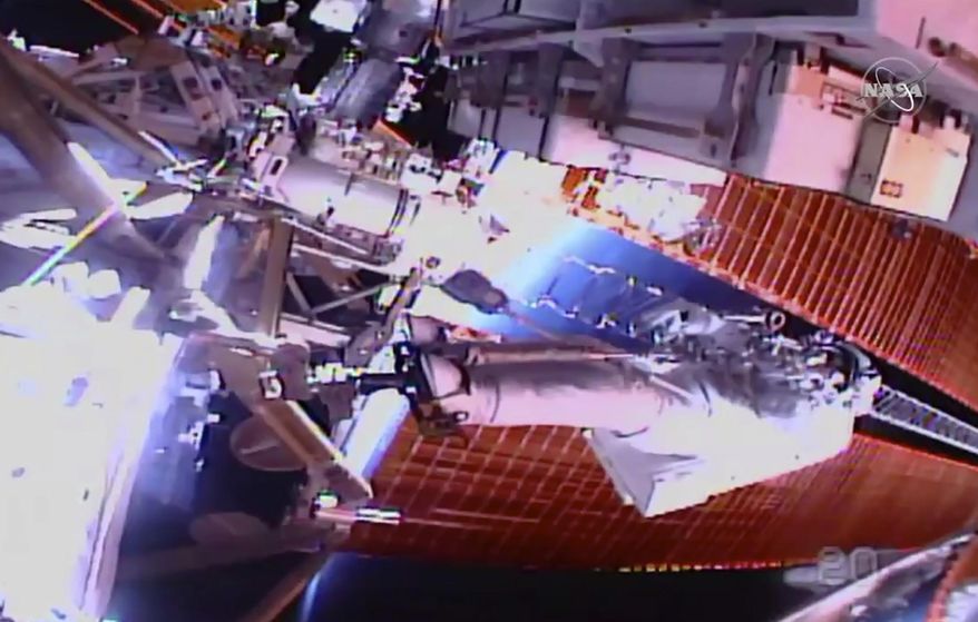 In this image taken from NASA video, NASA astronaut Chris Cassidy works outside the International Space Station on Thursday, July 16, 2020.  Cassidy and Bob Behnken ventured out on their third spacewalk over the past few weeks to remove six more old batteries in the space station’s power grid, and replace them with new, improved ones. (NASA via AP)