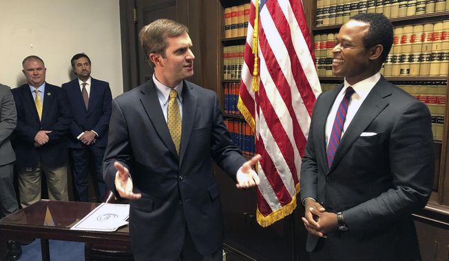FILE - In this Dec. 17, 2019, file photo, Kentucky Gov. Andy Beshear, left, talks about the role of attorney general in Frankfort, Ky., shortly before Daniel Cameron, right, is sworn in as Kentucky&#x27;s attorney general. Partisan bickering is nothing new in Kentucky, but tensions are ratcheting up as coronavirus cases continue to rise. Beshear, a Democrat, is fending off legal challenges from Cameron, a Republican, over his executive actions during the pandemic. (AP Photo/Bruce Schreiner, File)