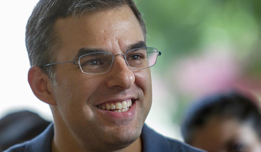 FILE - In this Aug. 21, 2019, file photo U.S. Rep. Justin Amash, I-Cascade Township, holds a constituent meeting in Grand Rapids, Mich. Amash of Michigan, a former Republican who was the lone GOP lawmaker to support the impeachment of President Donald Trump, is officially not running for reelection. (Cory Morse/The Grand Rapids Press via AP, File)