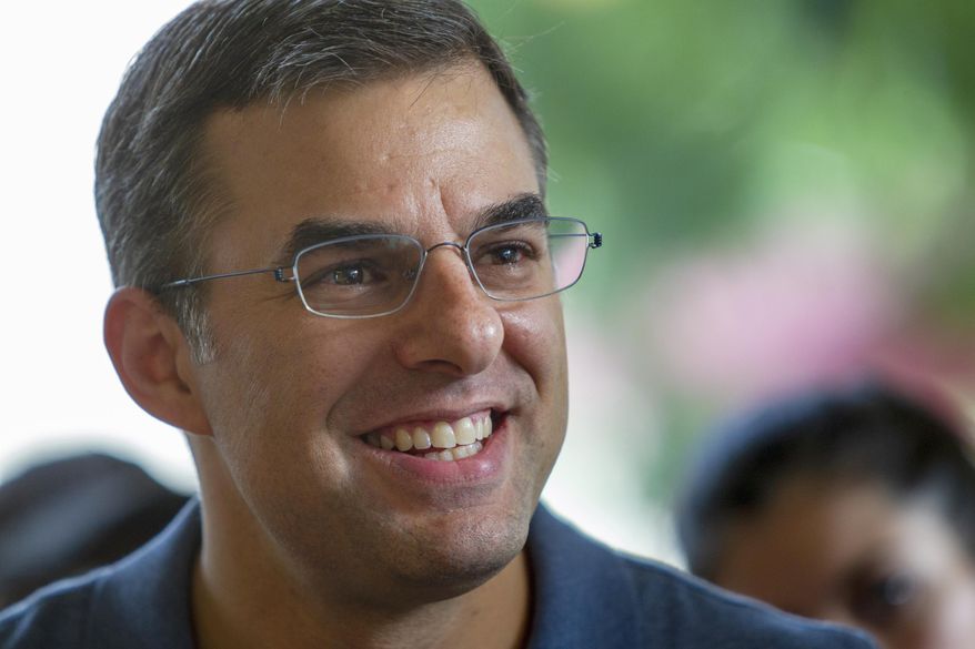 FILE - In this Aug. 21, 2019, file photo U.S. Rep. Justin Amash, I-Cascade Township, holds a constituent meeting in Grand Rapids, Mich. Amash of Michigan, a former Republican who was the lone GOP lawmaker to support the impeachment of President Donald Trump, is officially not running for reelection. (Cory Morse/The Grand Rapids Press via AP, File)