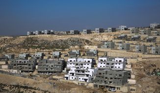 This Tuesday, Jan. 1, 2019, file photo, shows a new housing project in the West Bank settlement of Naale. Peter Beinart, an influential American commentator, has shocked the Jewish establishment and Washington policy-making circles by breaking a long-standing taboo: He has endorsed the idea of a democratic entity of Jews and Palestinians living with equal rights between the Jordan River and the Mediterranean. (AP Photo/Ariel Schalit, File)