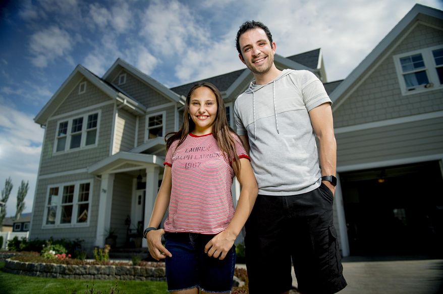 Isabel Rammell, 13, poses for a portrait with her non-biological brother, Skyler Rammell, outside of Isabel's home in Springville, Utah, on Thursday, July 16, 2020. Skyler will be donating his kidney to Isabel, and the hope is to have the procedure take place in August after the procedure was delayed due to COVID-19. (Isaac Hale/The Daily Herald via AP)