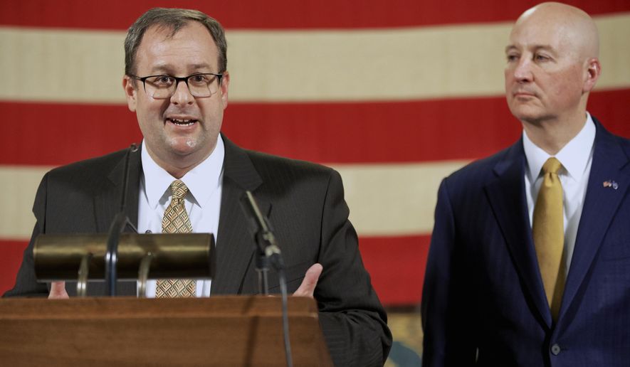 Nebraska Department of Education Commissioner Matt Blomstedt, left, speaks next to Gov. Pete Ricketts during a news conference on Thursday, March 16, 2020, in Lincoln, Neb. On Friday, Gov. Ricketts and Commissioner Blomstedt held a news conference to discuss Nebraska's plans to reopen public schools. (AP Photo/Nati Harnik)