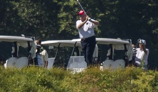 President Donald Trump plays golf at Trump National Golf Club in Sterling, Va., as seen from the other side of the Potomac River in Darnestown, Md., Saturday, July 18, 2020. (AP Photo/Manuel Balce Ceneta)