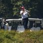 President Donald Trump plays golf at Trump National Golf Club in Sterling, Va., as seen from the other side of the Potomac River in Darnestown, Md., Saturday, July 18, 2020. (AP Photo/Manuel Balce Ceneta)