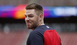 FILE - In this Oct. 5, 2019, file photo, Atlanta Braves&#x27; Freddie Freeman looks over his shoulder as he enters the batting cage during a baseball workout in St. Louis. Freeman does not know if he has time to be ready for the Braves&#x27; opener at the New York Mets. Following a scary journey in his battle with COVID-19, Freeman knows he is grateful to even have a chance. (AP Photo/Jeff Roberson, File)