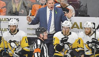 Pittsburgh Penguins coach Mike Sullivan makes his point with referee Kelly Sutherland during the second period in Game 6 of the first-round NHL hockey playoff series against the Philadelphia Flyers at the Wells Fargo Center, on April 22, 2018 photo, in Philadelphia. Where would the coach who turned around the Penguins’ 2015-16 season spend his day with the Stanley Cup? In the heart of Bruins country, at his old high school, Boston College High School. (Peter Diana/Pittsburgh Post-Gazette via AP)