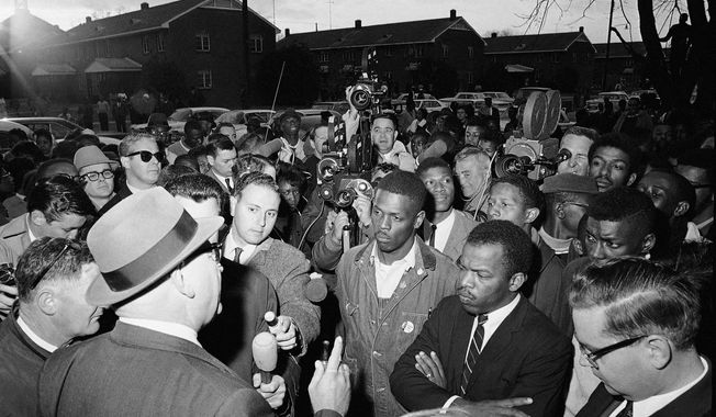 FILE - In this Feb. 23, 1965, file photo, Wilson Baker, left foreground, public safety director, warns of the dangers of night demonstrations at the start of a march in Selma, Ala. Second from right foreground, is John Lewis of the Student Non-Violent Committee. Lewis, who carried the struggle against racial discrimination from Southern battlegrounds of the 1960s to the halls of Congress, died Friday, July 17, 2020. (AP Photo/File)