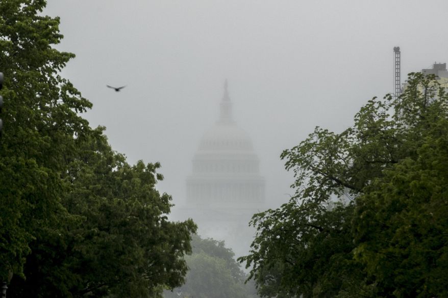 In this May 22, 2020, file photo the dome of the U.S. Capitol Building is visible through heavy fog in Washington. With COVID-19 cases hitting alarming new highs and a grim rising death toll, the pandemic&#x27;s devastating cycle is happening all over again, leaving Congress little choice but to engineer another costly rescue. (AP Photo/Andrew Harnik, File)