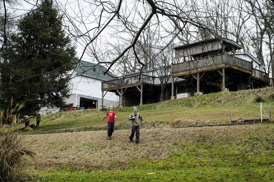 Children run across the backyard of ZigZag, an unschooling collective in Asheville, N.C., on Jan. 13, 2020. Unschooling is a student-driven form of homeschooling. As North Carolina families sort through uncertainties surrounding the 2020-21 school year, some anticipate already increasing home-schooling rates will soar as a result of the coronavirus pandemic. (Angela Wilhelm/The Asheville Citizen-Times via AP)